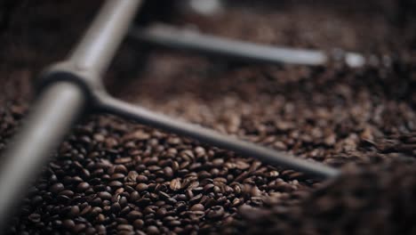 coffee roasting process - coffee beans in roasting machine. close up in slow motion.