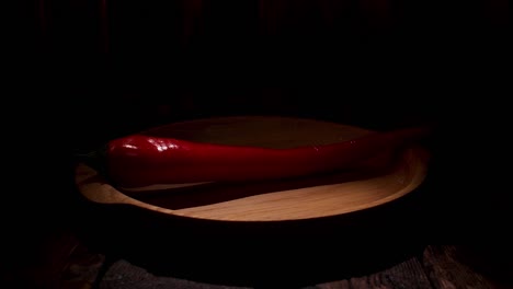 red chili pepper on wooden plate