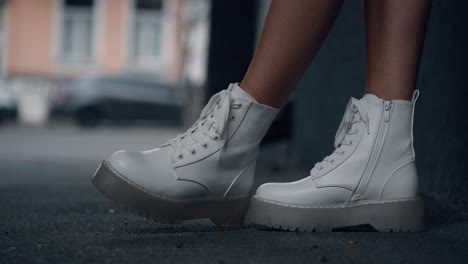 Caucasian-girl-urban-shoes-standing-in-city-background-modern-building.