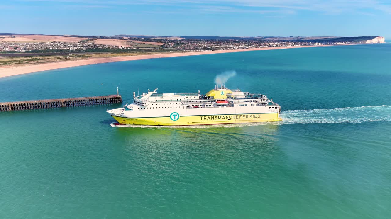 Stunning 4K drone footage of the Dieppe to Newhaven ferry arriving at port, set against the backdrop of clear blue skies, sparkling waters, and the picturesque South Downs.