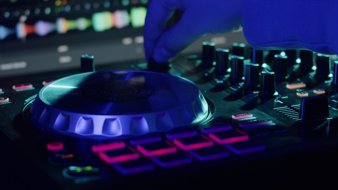 DJ with headphones and sunglasses playing music on festival in night club. Techno musician performing at nightclub for concert crowd of people, city bar.