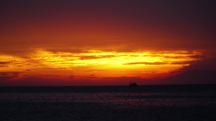 Majestic vibrant yellow and red coastline sunset in South Vietnam, time lapse