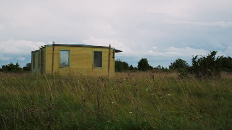 Exterior-view-of-an-abandoned-shack-with-broken-windows