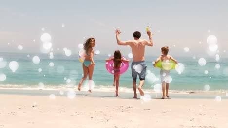 moving spots of white light with family on beach