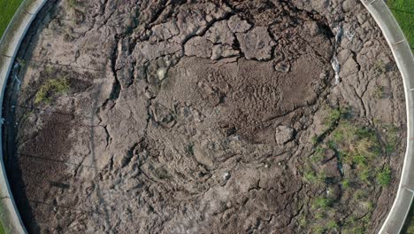 descending top down aerial on manure, slurry pit