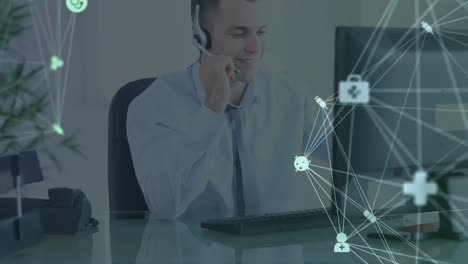 Animation-of-network-of-connections-and-icons-over-businessman-wearing-headset