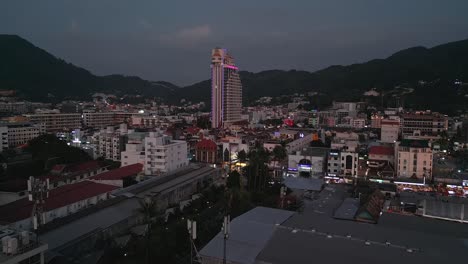 nighttime cityscape with mountains