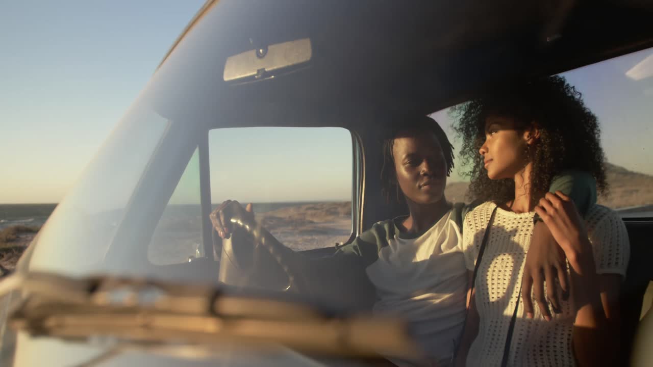 Couple sitting together in pickup truck a beach 4k
