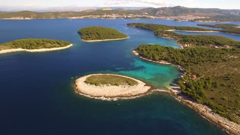 Drone-moving-away-from-2-kayaks-and-revealing-blue-lagoon-with-small-islands