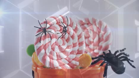 Glowing-tunnel-against-spiders-and-candies-in-halloween-pumpkin-bucket-against-white-background