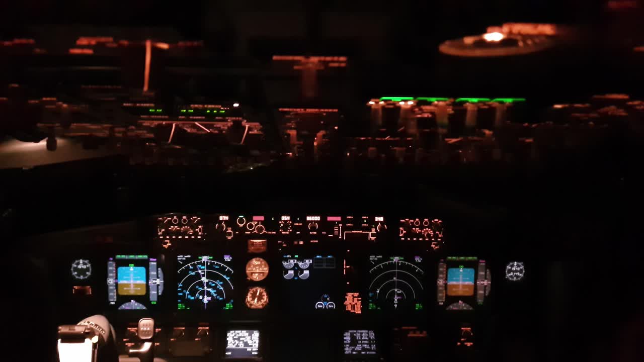 Cockpit of airplane with illuminated instruments at night. handheld