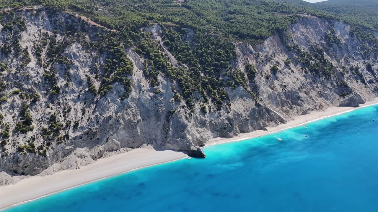 Greece,Ionian Islands,West Coast of Lefkada,Aerial Panoramic view panning from right to left of Egremni Beach from the deep blue sea. Whole coast line