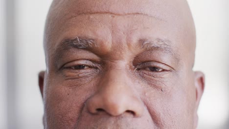 Video-close-up-portrait-of-the-opening-eyes-of-senior-african-american-male-doctor
