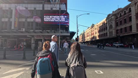 pedestrians and scooters navigate a bustling crosswalk