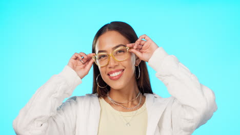 Blue-background,-smile-and-face-of-a-woman