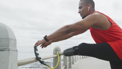 side view man with prosthetic leg stretching