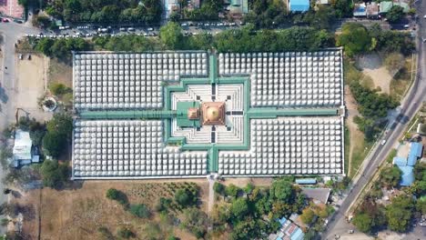 aerial overhead shot showcases the mesmerizing arrangement of white stupas at the sandar mu ni pagoda in mandalay, myanmar, highlighting the symmetrical layout and the central golden structure,