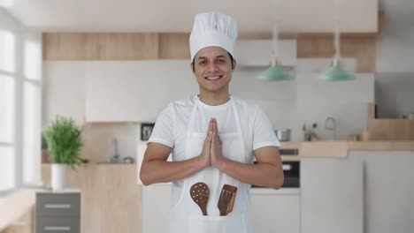 happy indian professional chef doing namaste