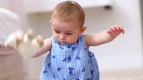 cute baby playing with sheep teddy