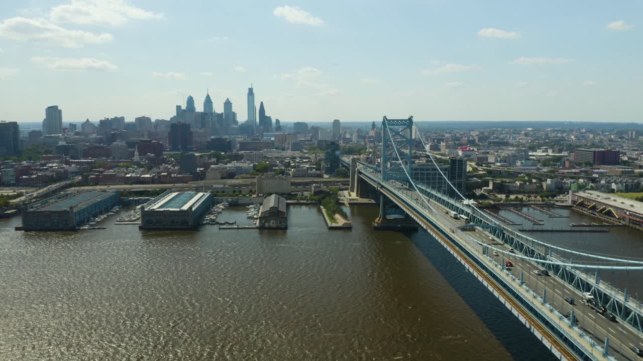 Aerial - Pullback to reveal bridge to urban city during summer afternoon