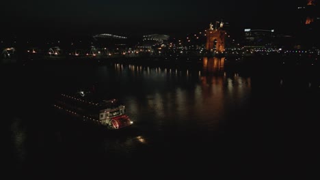 Pan-Nocturno-Aéreo-De-Vapor-De-Paletas-Y-Puente-Colgante-En-El-Río-Ohio,-Cincinnati,-Ohio