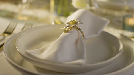 close up of napkin in ring on table set for meal at wedding reception in restaurant 3