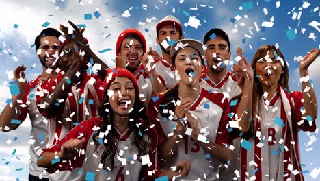 group of fans cheering for their team with confetti