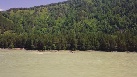 Aerial-Flying-over-mountain-river-with-a-rapid-current-Also-visible-river-rapids