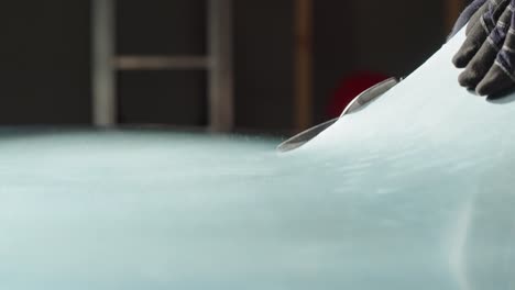 applying protective film to car hood