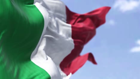 detail of the national flag of italy waving in the wind on a clear day