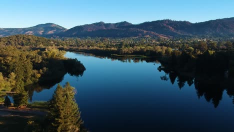 aerial fly over beautiful lake at sunrise