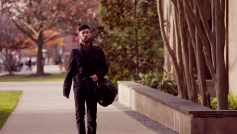 Young Man Walking on College Campus