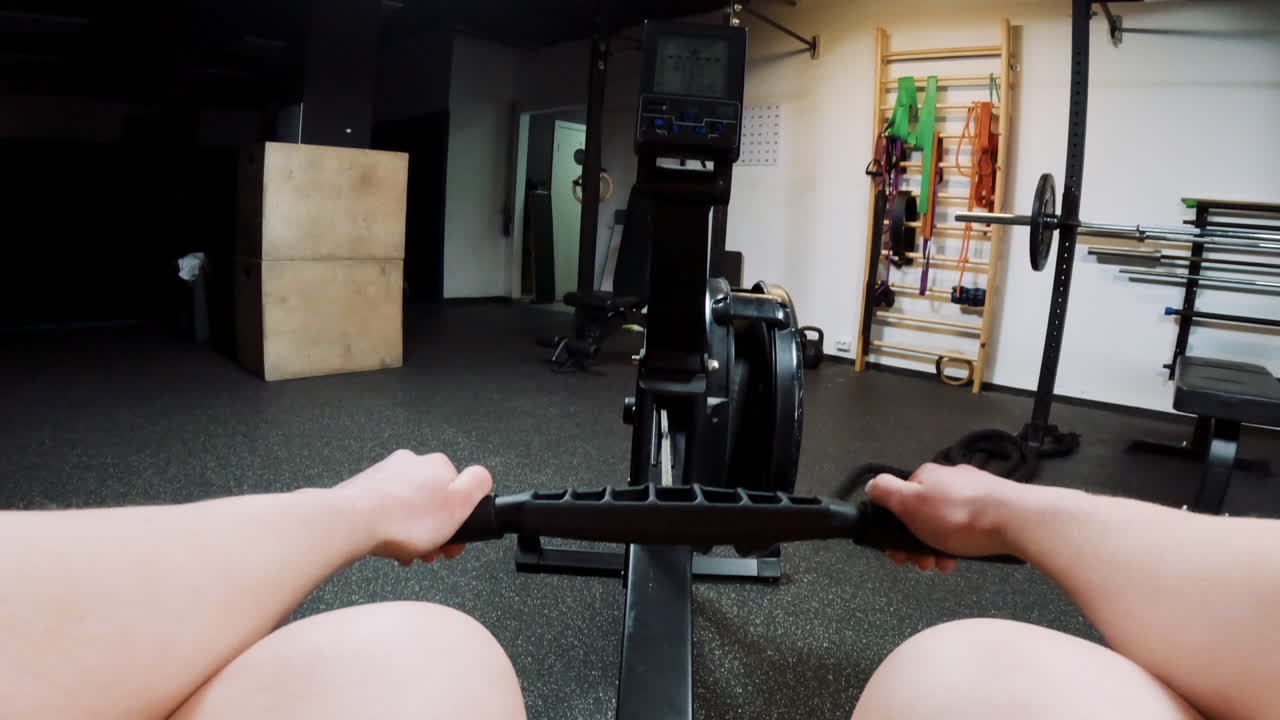 Person Rowing on a Machine in a Gym