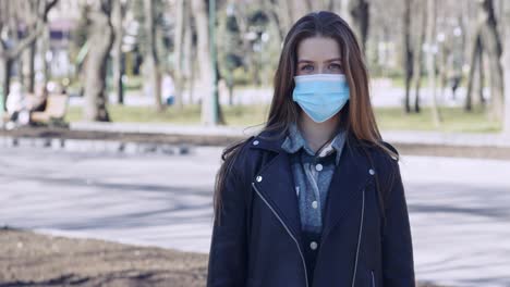 woman wearing a face mask in a park