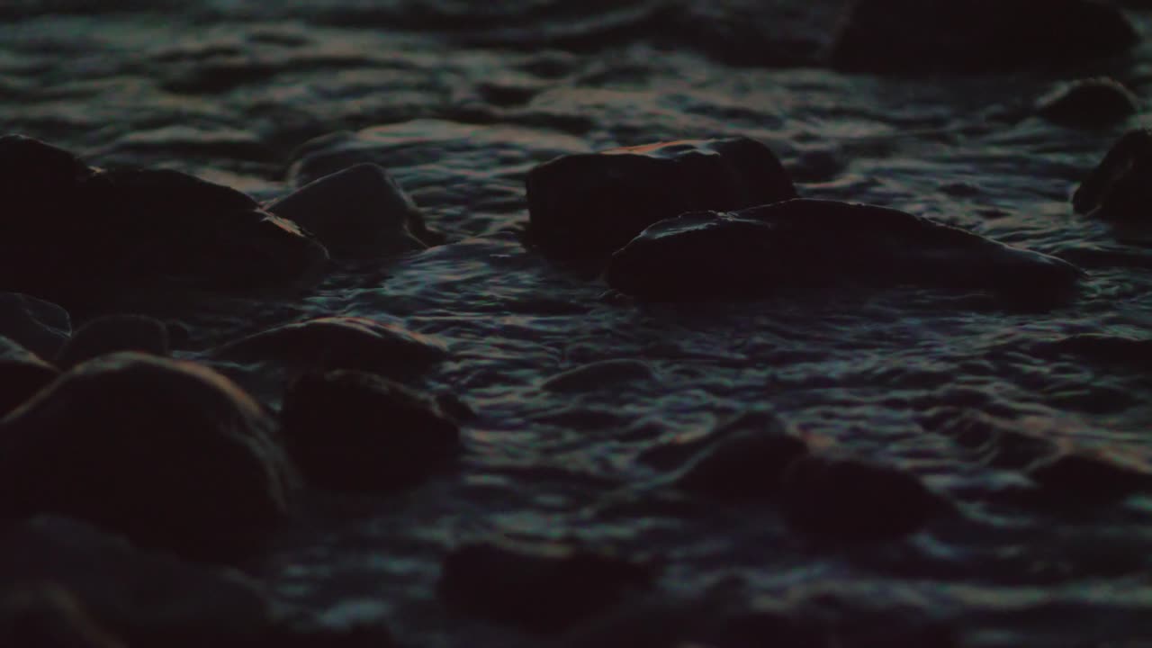 river splash on the rocks in the evening sunset