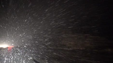 heavy snow falling while driving on freeway