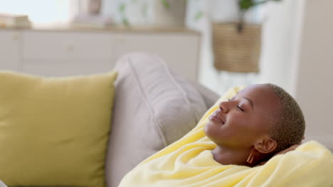 Black-woman,-home-and-hands-behind-head-on-sofa-to