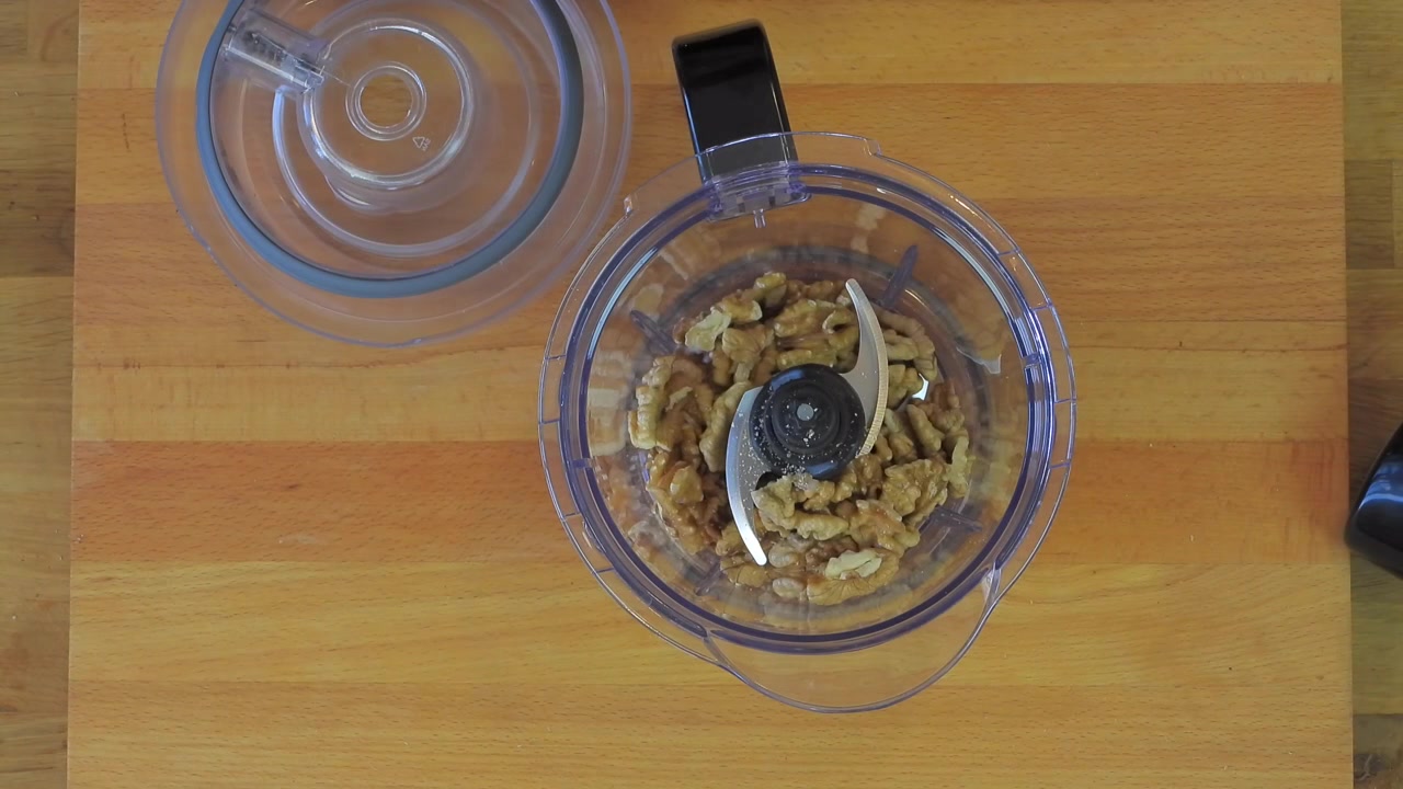 Person Preparing Walnuts in a Food Processor