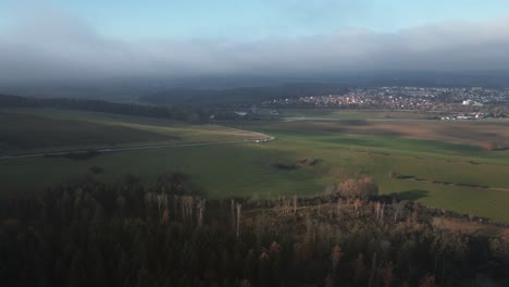 a breathtaking wide-angle aerial view of the countryside near hohenzollern, revealing lush forests, and winding village roads in a stunning panoramic shot.