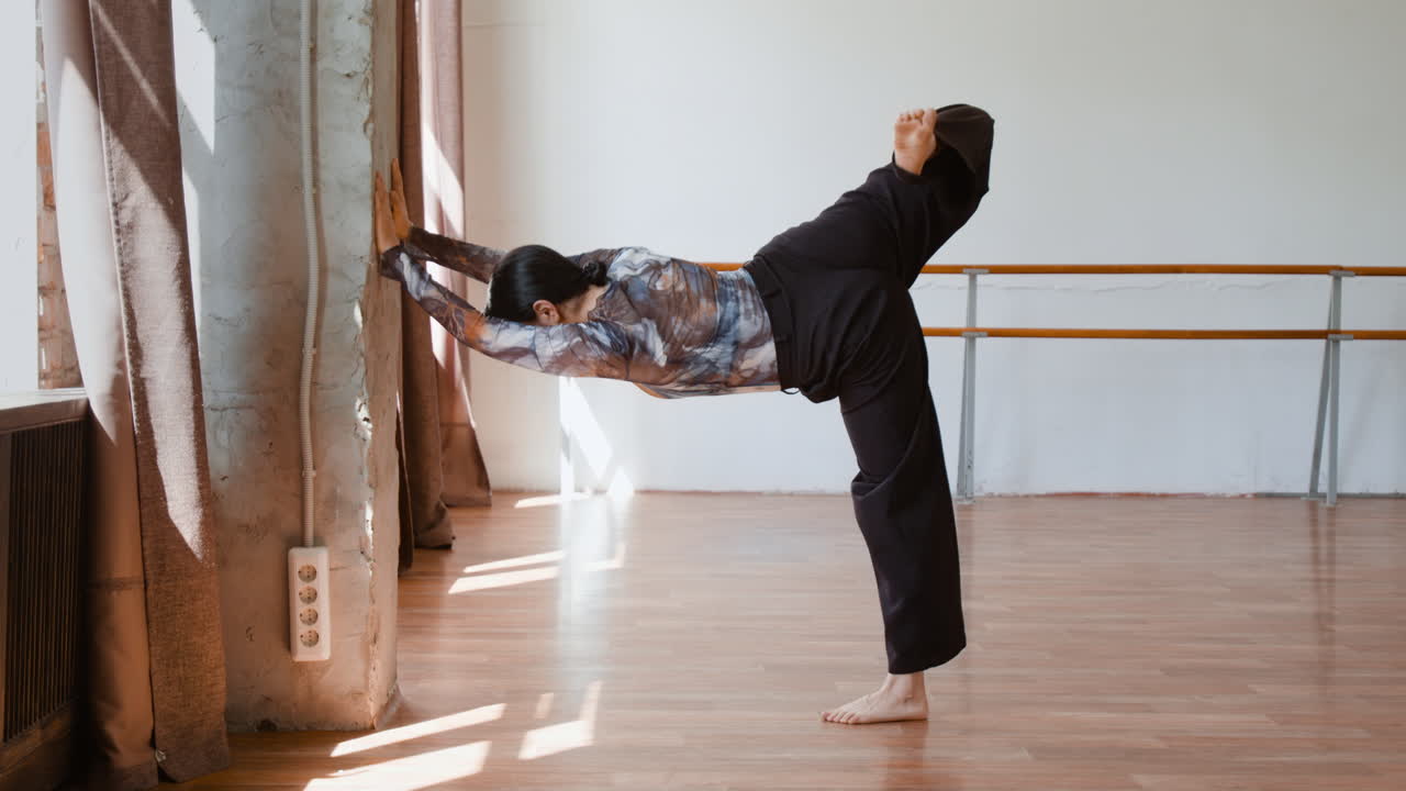 Woman Stretching and Exercising in a Dance Studio