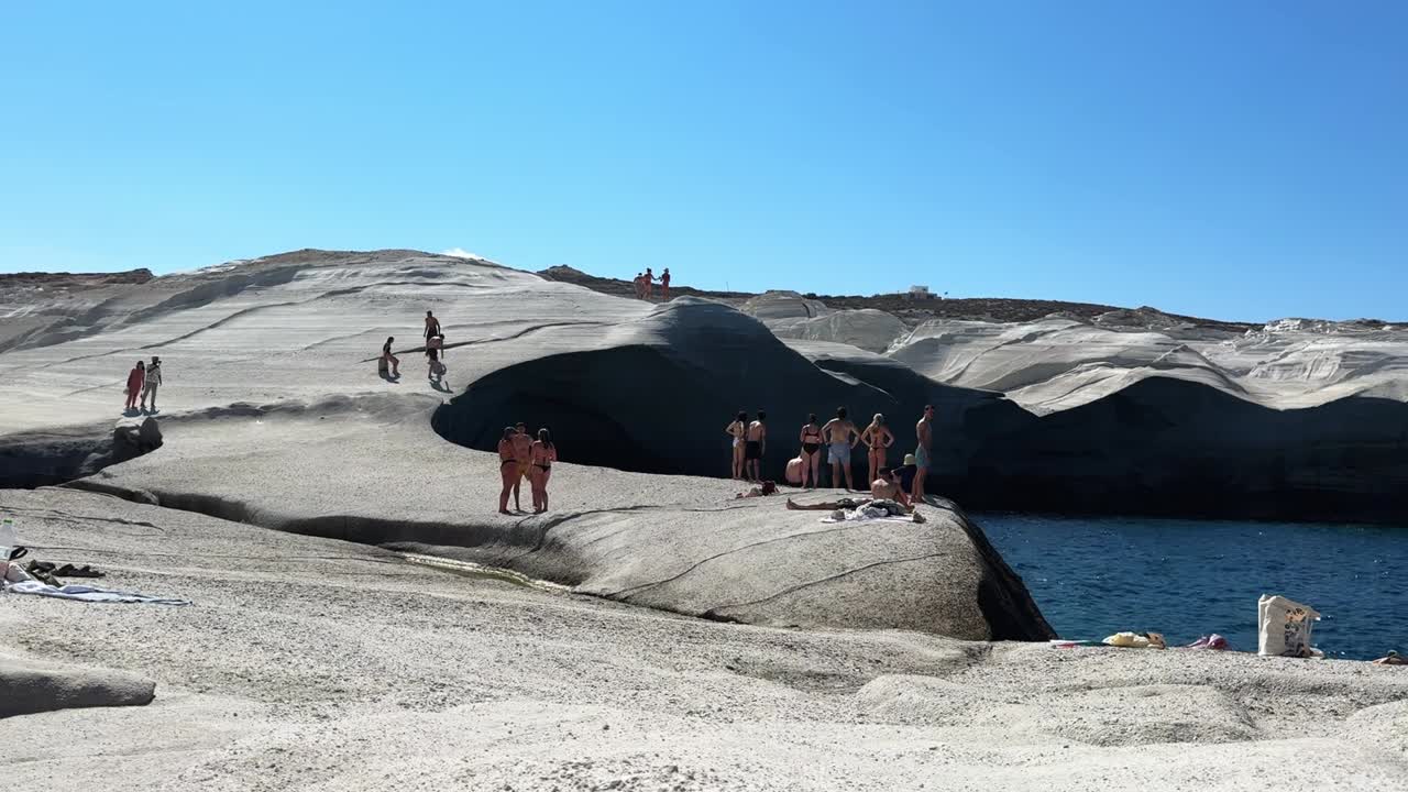 People enjoying a sunny day at a white rock beach