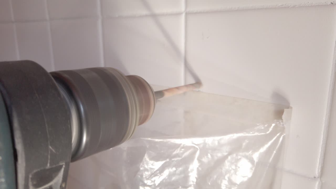 Power Drill Creating a Hole in White Ceramic Tile
