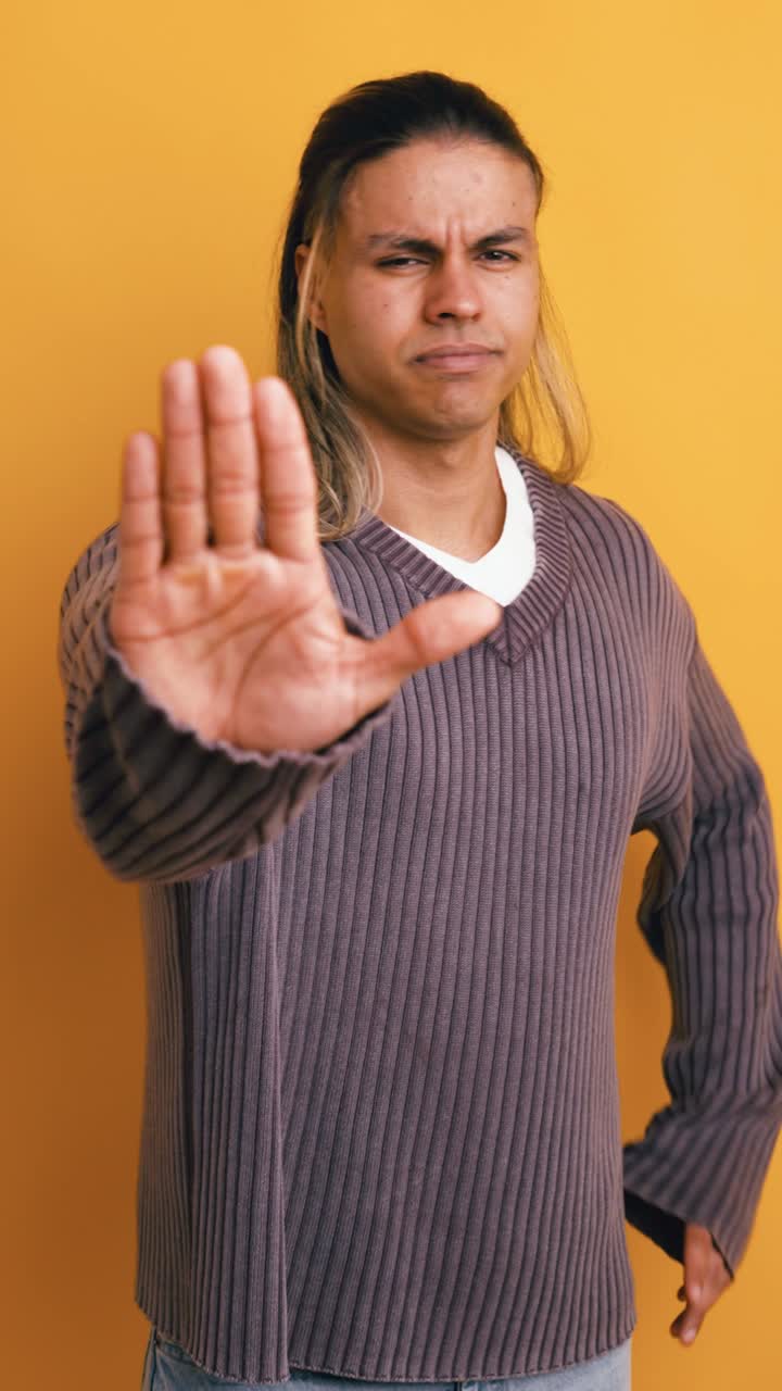 Serious Young Man Making Stop Hand Gesture