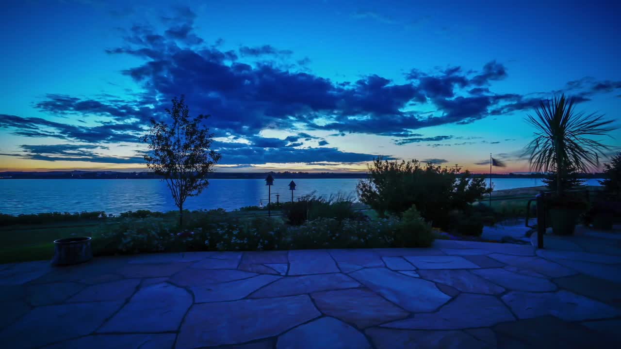 Sunrise time lapse across lake from flag stone patio. Lake side real estate. Fort Collins, Colorado