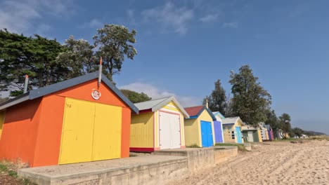 vibrant beach boxes along sandy foreshore