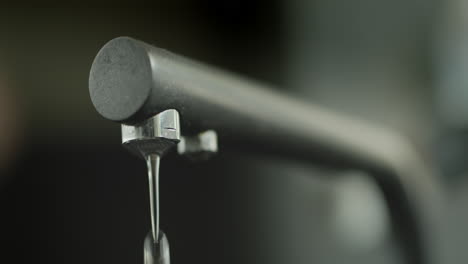 water drips from the kitchen faucet. resource saving and ecology concept. slow motion 4k video