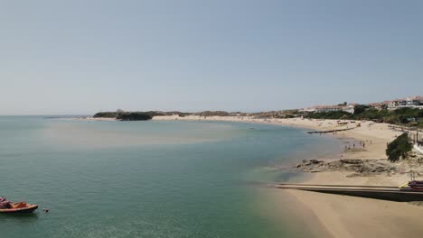 vila nova de milfontes by mira river, scenic seascape, aerial pullback