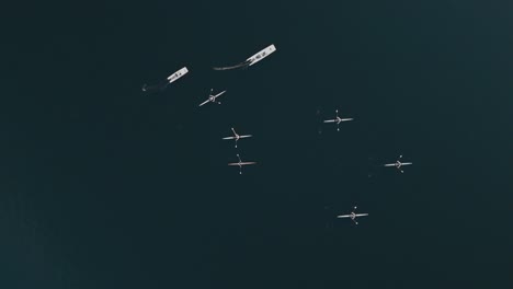 호수 에서 훈련 하는 rowers 의 birdseye 추적  과 함께 코치 들 이 발사 에서 지시