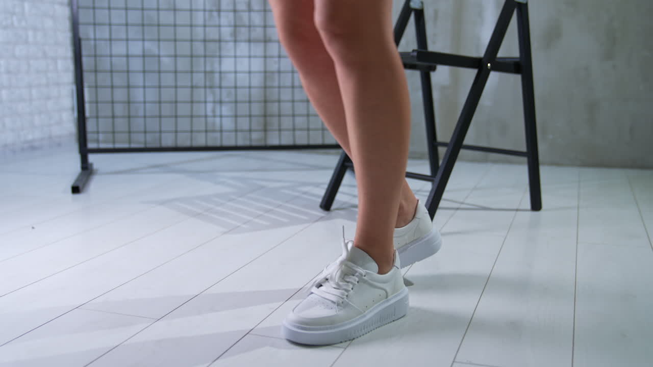 Woman's Legs and White Sneakers