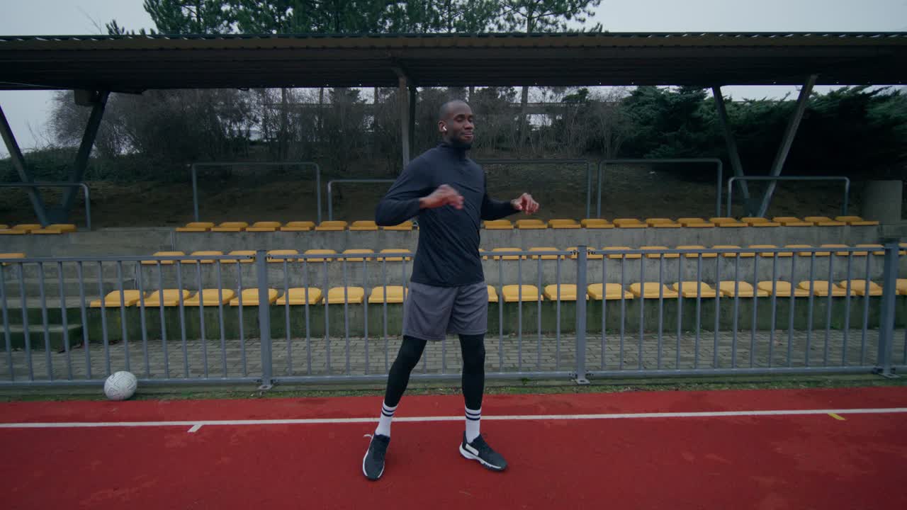 Man warming up at a soccer stadium